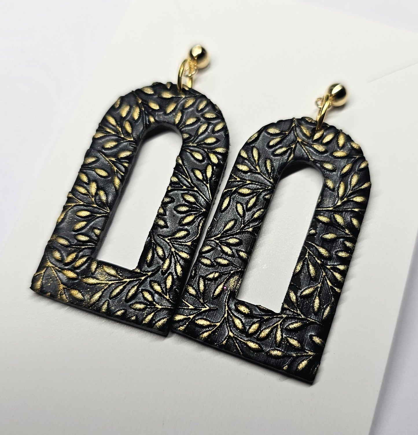 Black and gold arch earrings