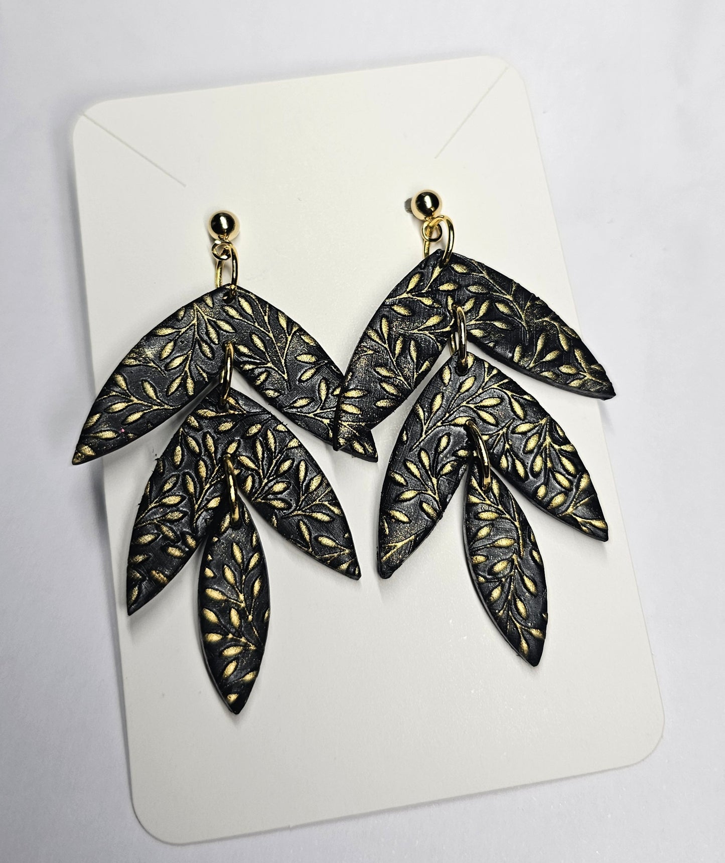 Black and gold triple leaf earrings