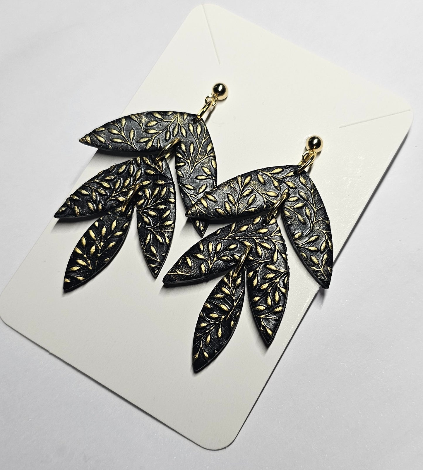 Black and gold triple leaf earrings